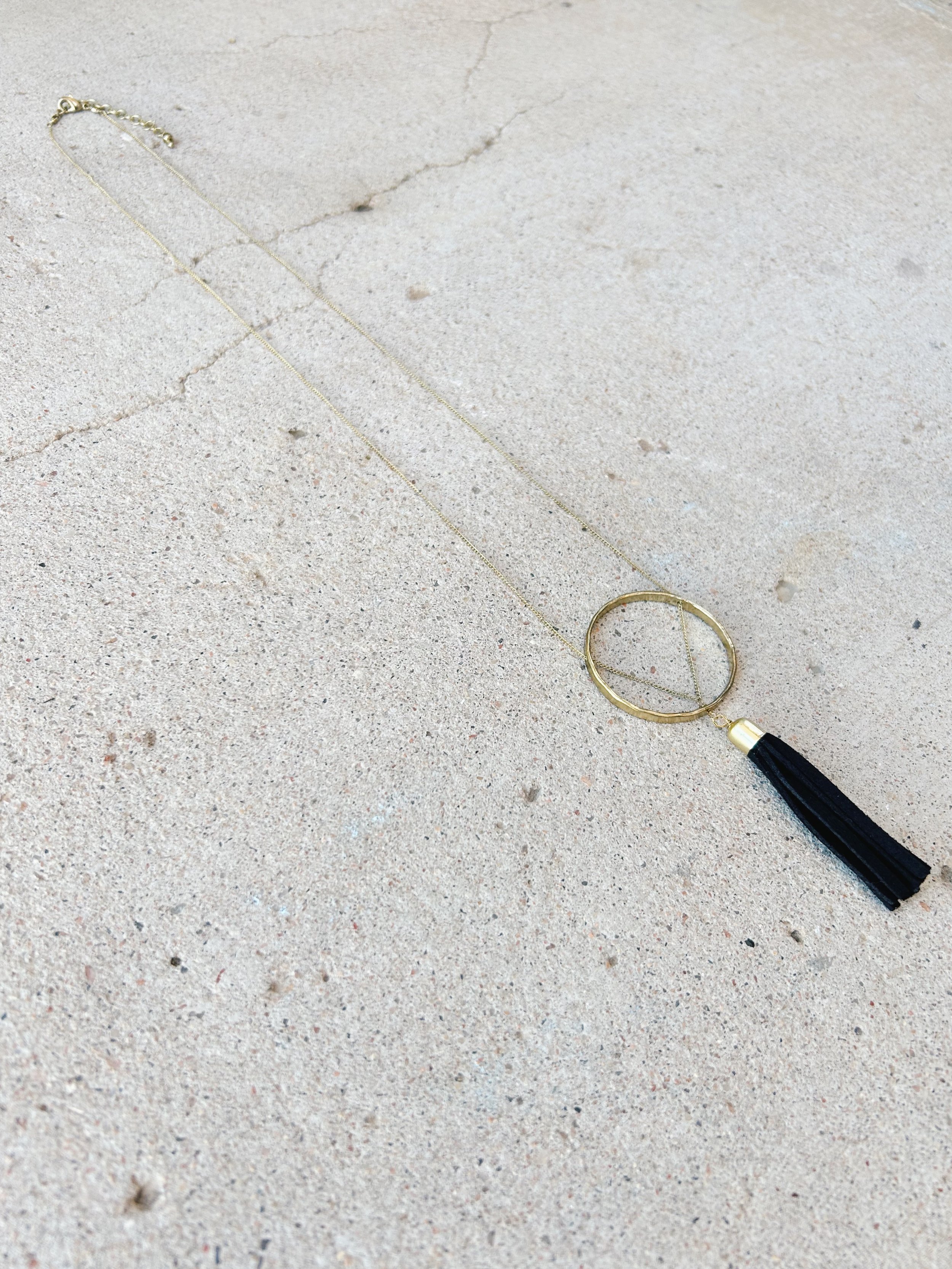 The Ellaria Tassel Necklace has a black suede tassel.