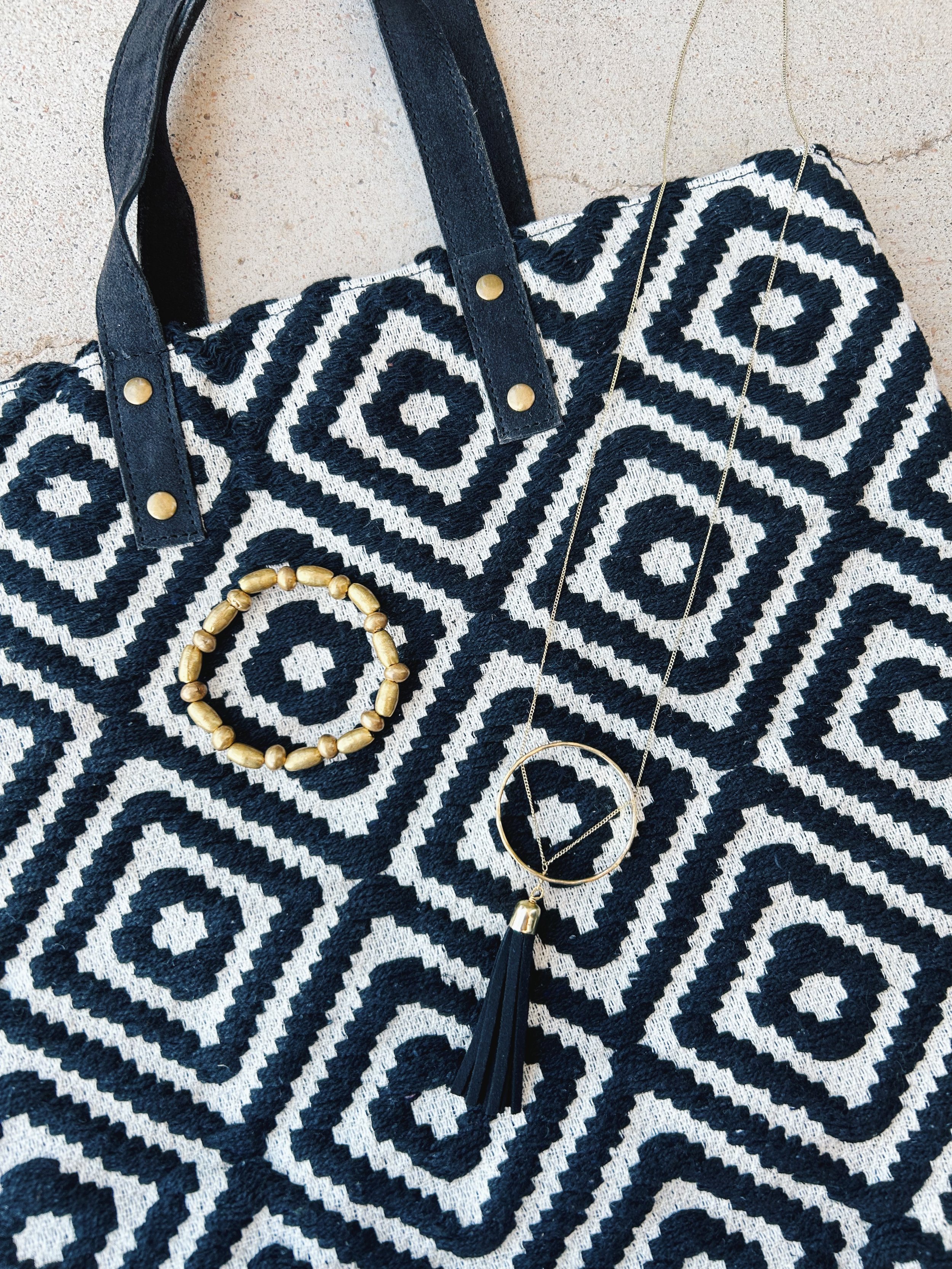 The Ellaria Tassel Necklace pairs well with the Meander Tote and the Gold Shell Bracelet.