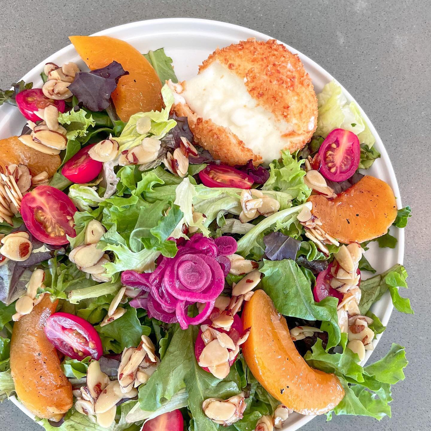 When you're craving cheese but also craving greens... cue our Peach Burrata Salad featuring grilled peaches, lightly fried burrata cheese, and our house made balsamic vinaigrette.