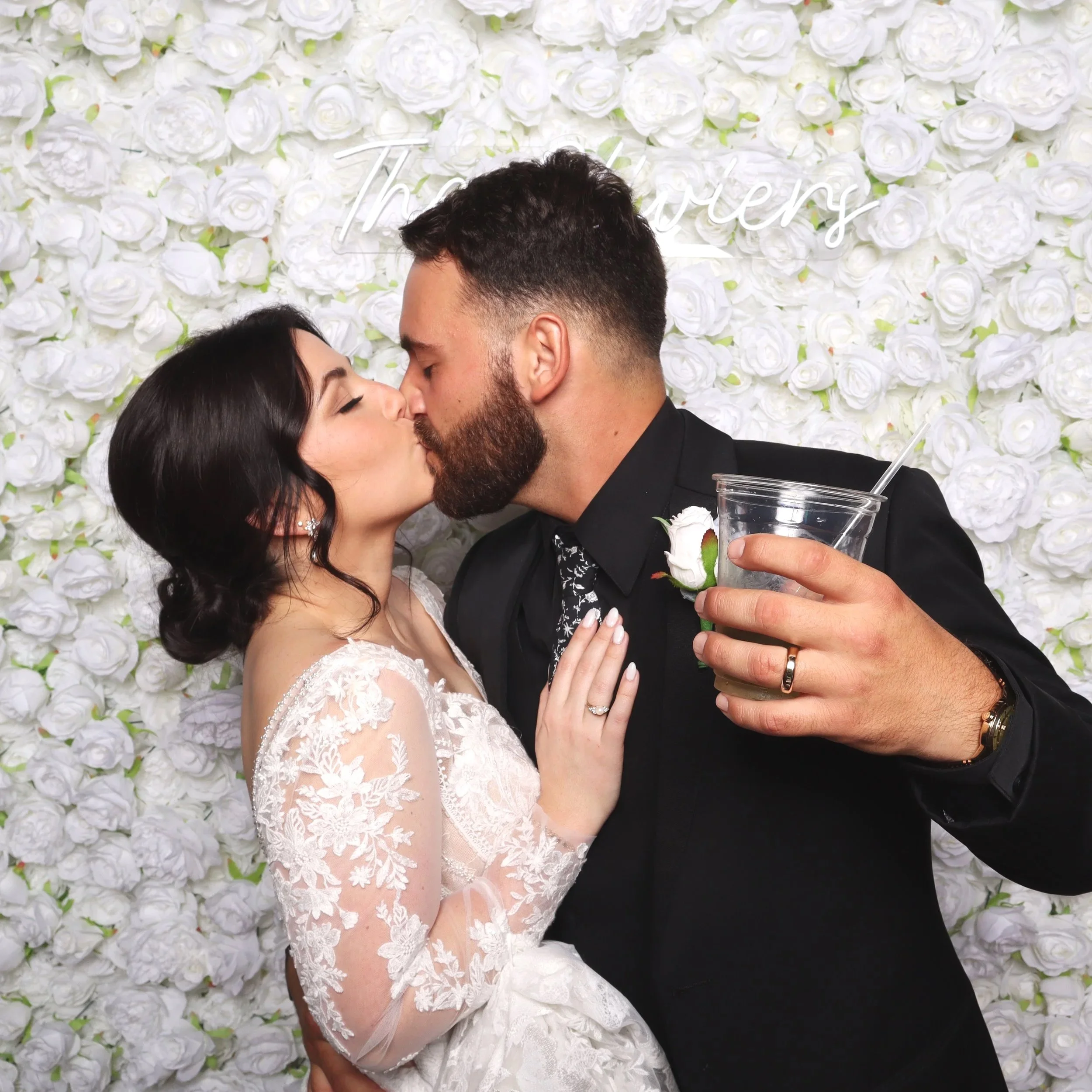 A couple kissing for a photo booth pic in Lafayette, LA