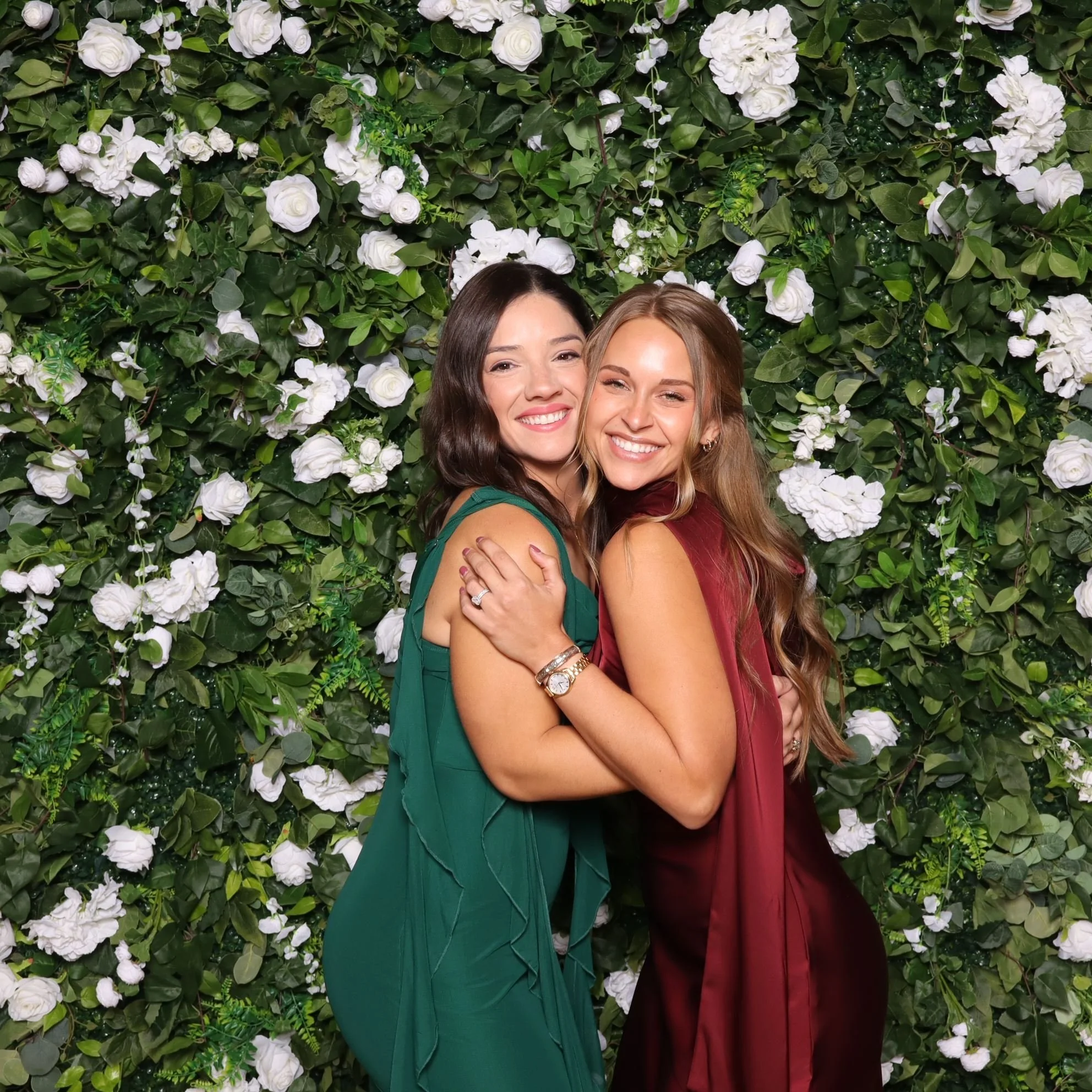 Two friends embracing each other for a pic using Bai Booth at an event in Lafayette