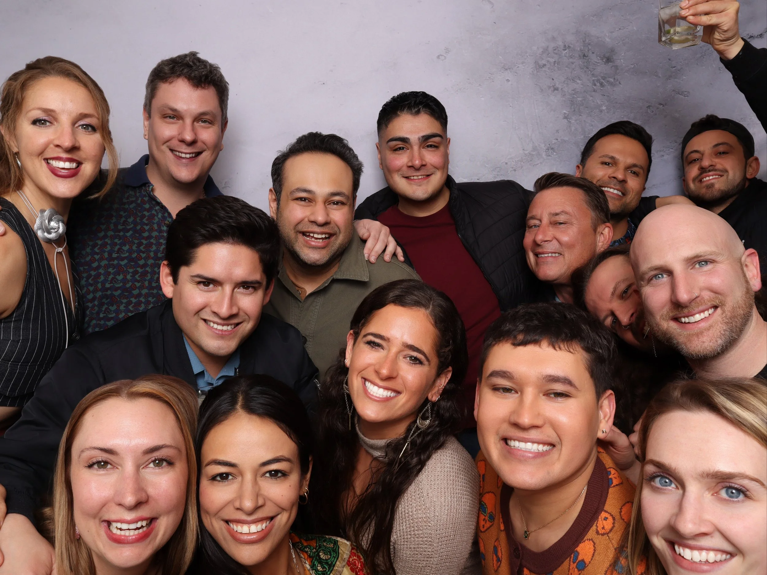 Group of friends smiling together for a photo at an indoor event