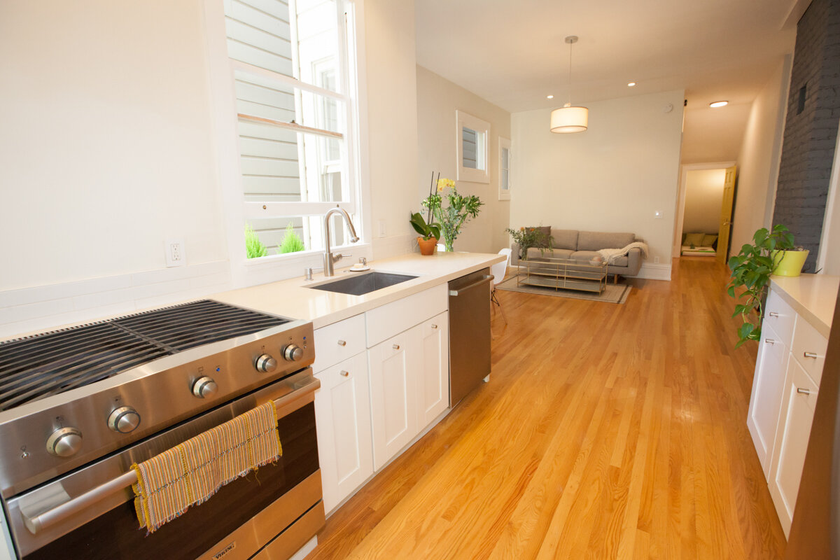 Professional real estate photography of a modern kitchen and living room
