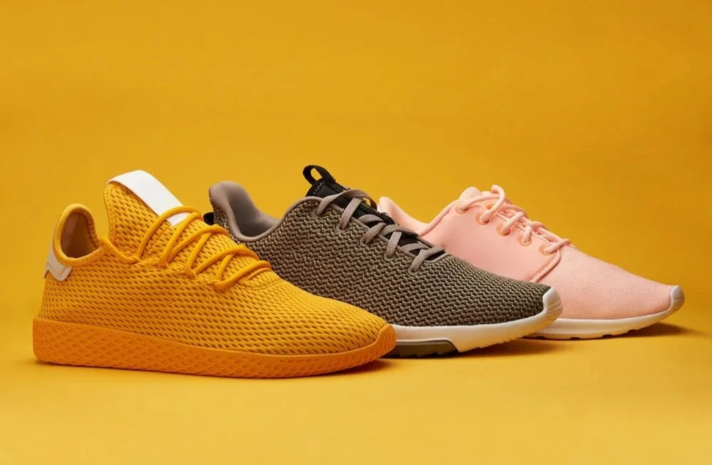 3 shoes lined up with a bright yellow background