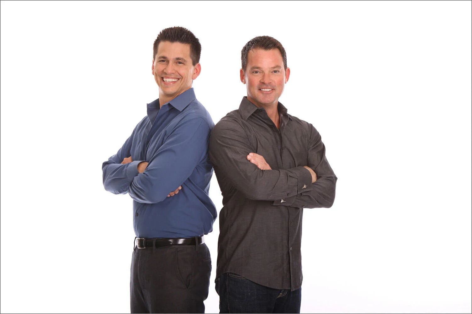 Professional corporate headshots of two male business professionals with arms crossed