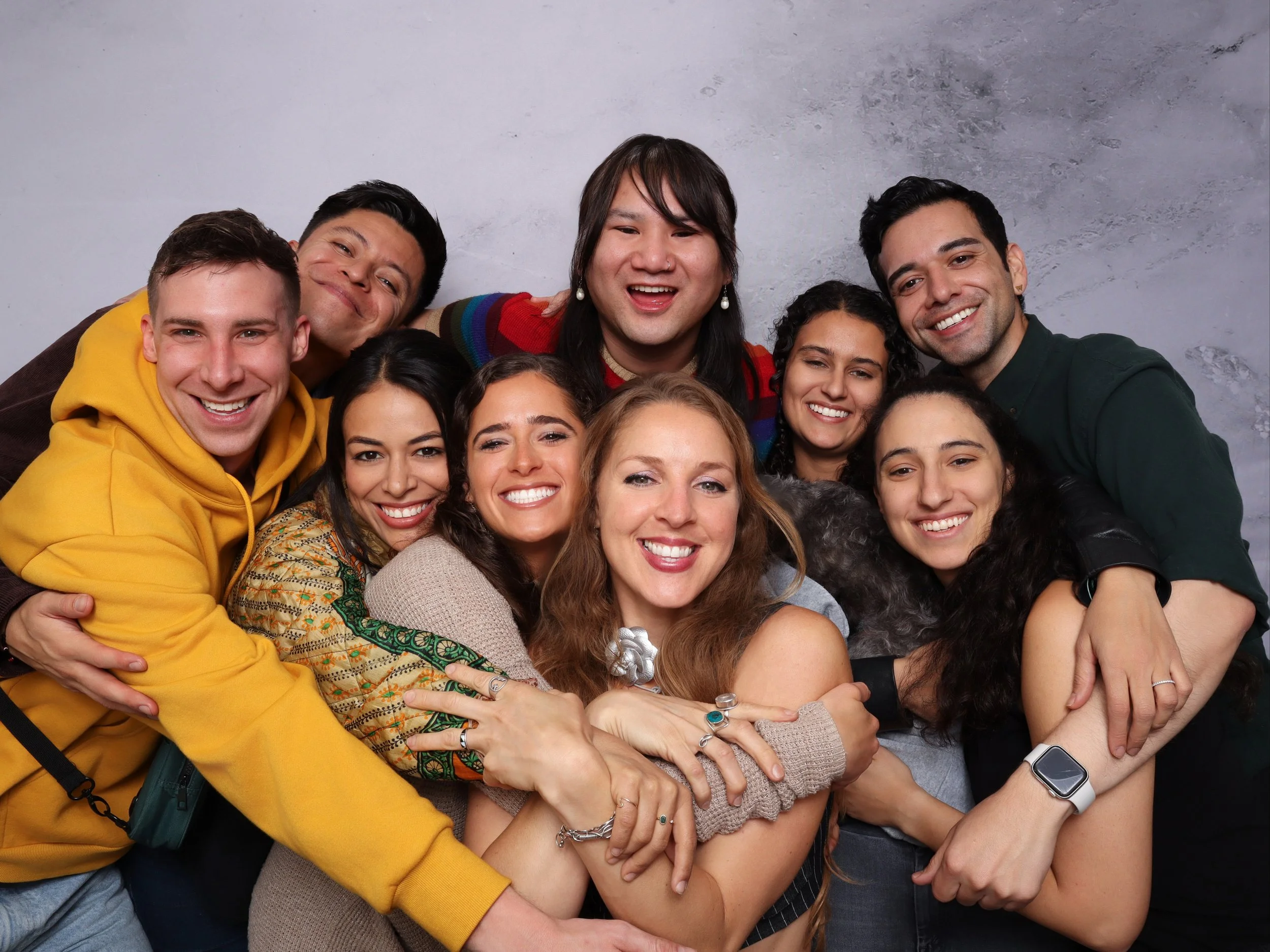 Group of friends posing together at a photo booth during a celebration event