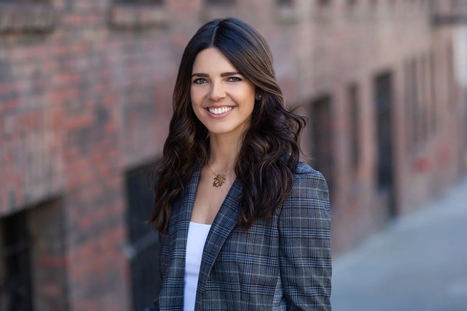 Woman posing for headshot in outdoor setting