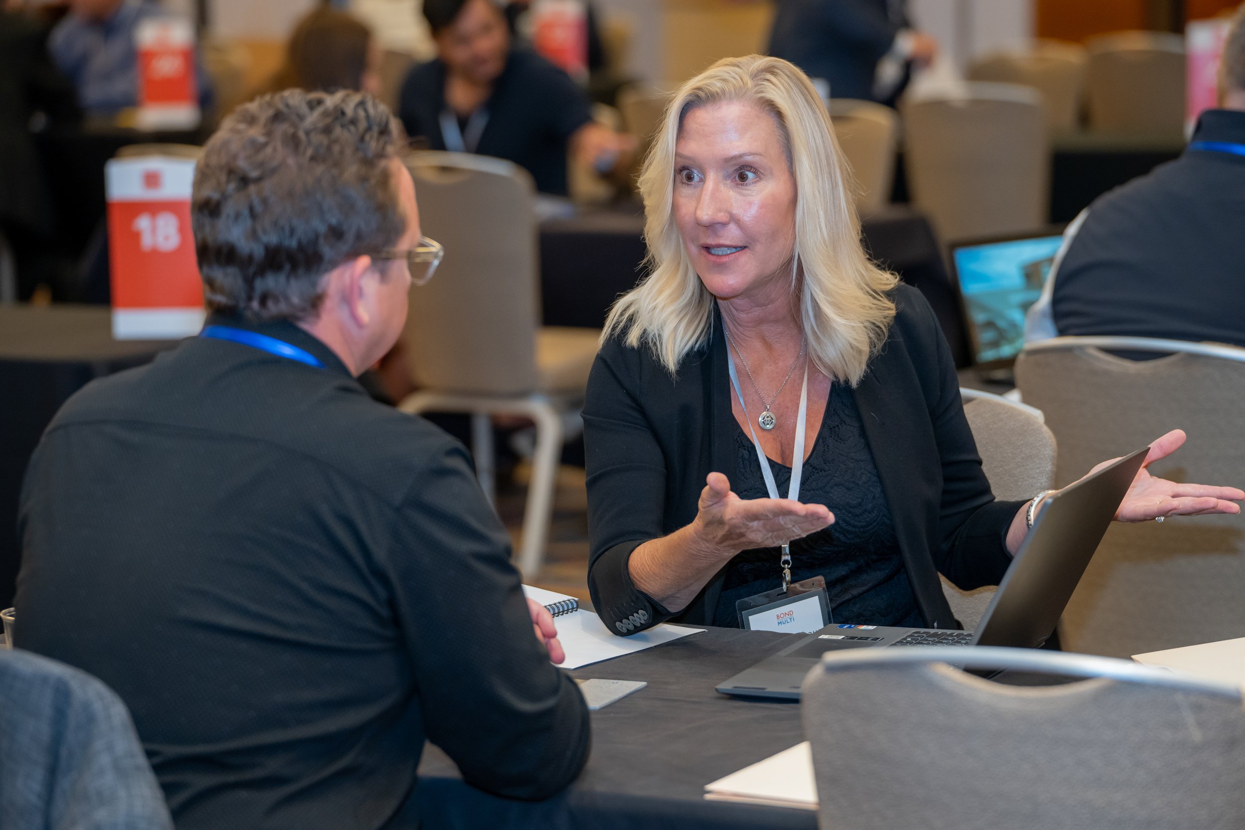 orporate conference attendees discussing business opportunities.