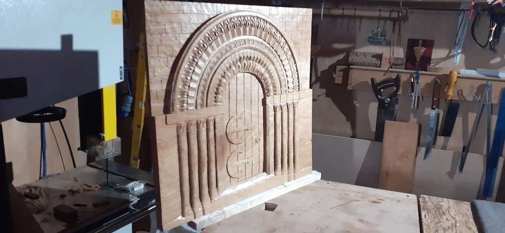 A carved representation of a Romanesque doorway in oak for a private client