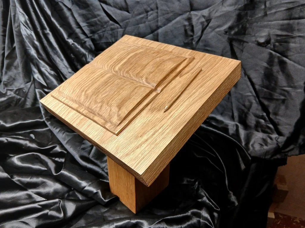 A Scorers Trophy in oak carved for the Gloucestershire Association of Cricket Officials
