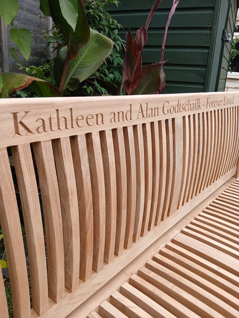Dedication carved into a client's bench