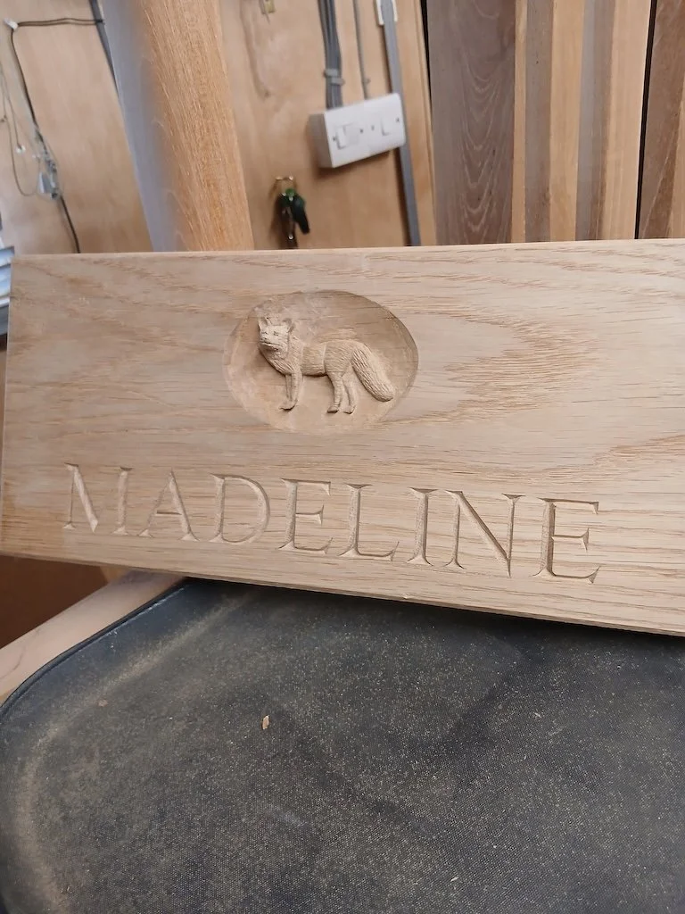 Name sign with fox craved in relief