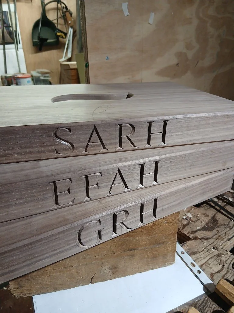 Carved initials into walnut stool seats for a private client