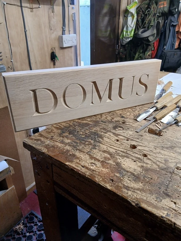 80mm high incised lettering carved into oak for a house sign