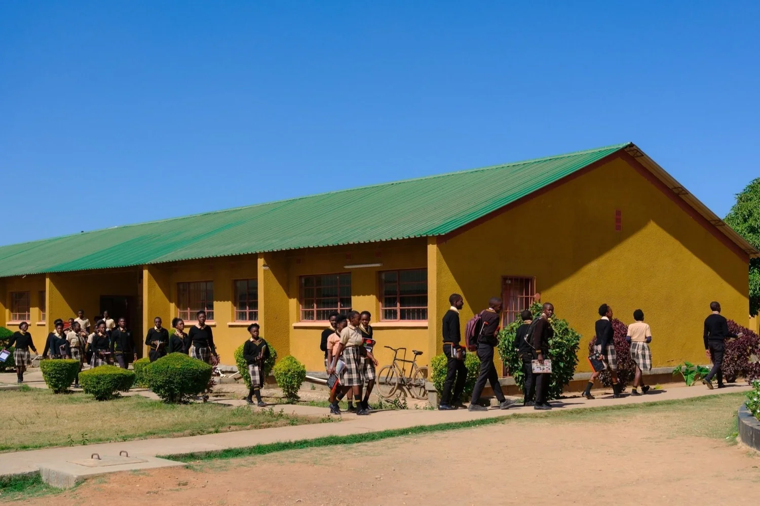 Young people outside a school building in Zambia.
