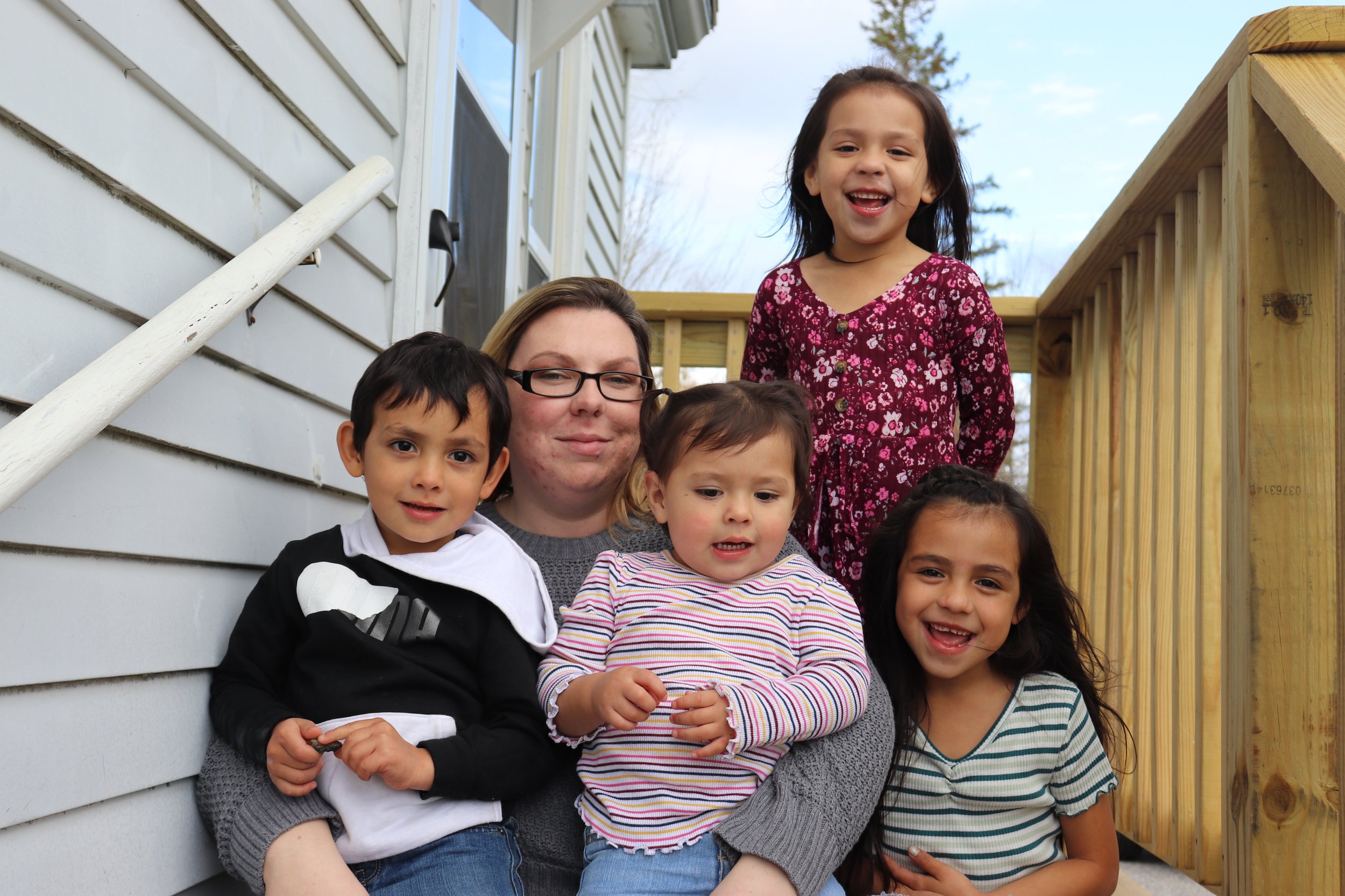 The DeAngelis family on the porch of their new home 