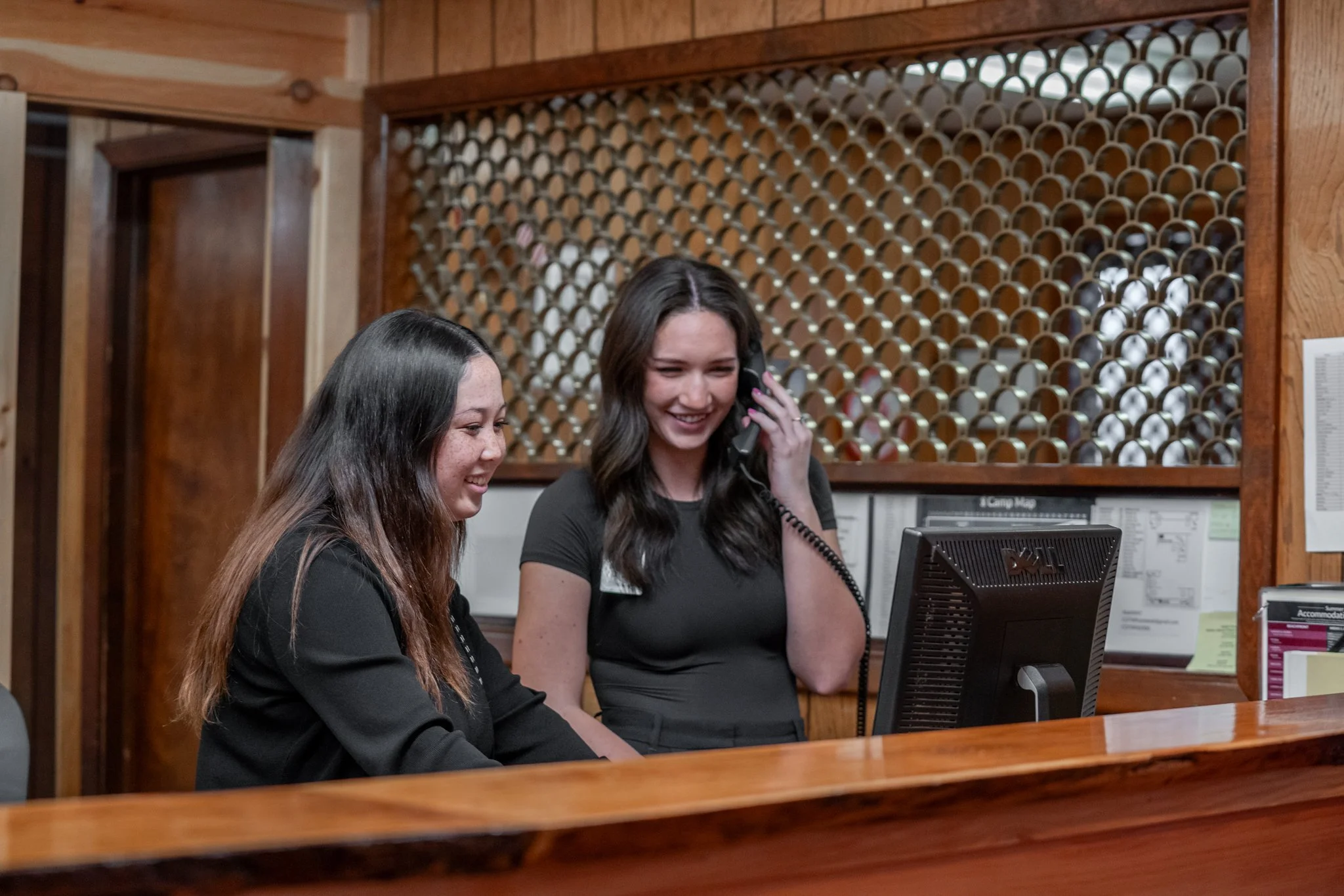 CAMP-of-the-WOODS Intern answering the phone at the Front Desk