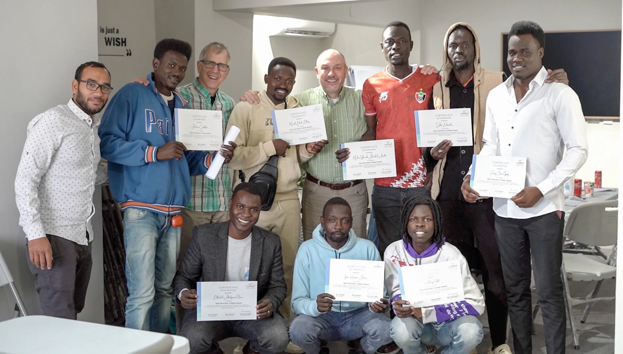 Electricity Graduates alongside COTW Members