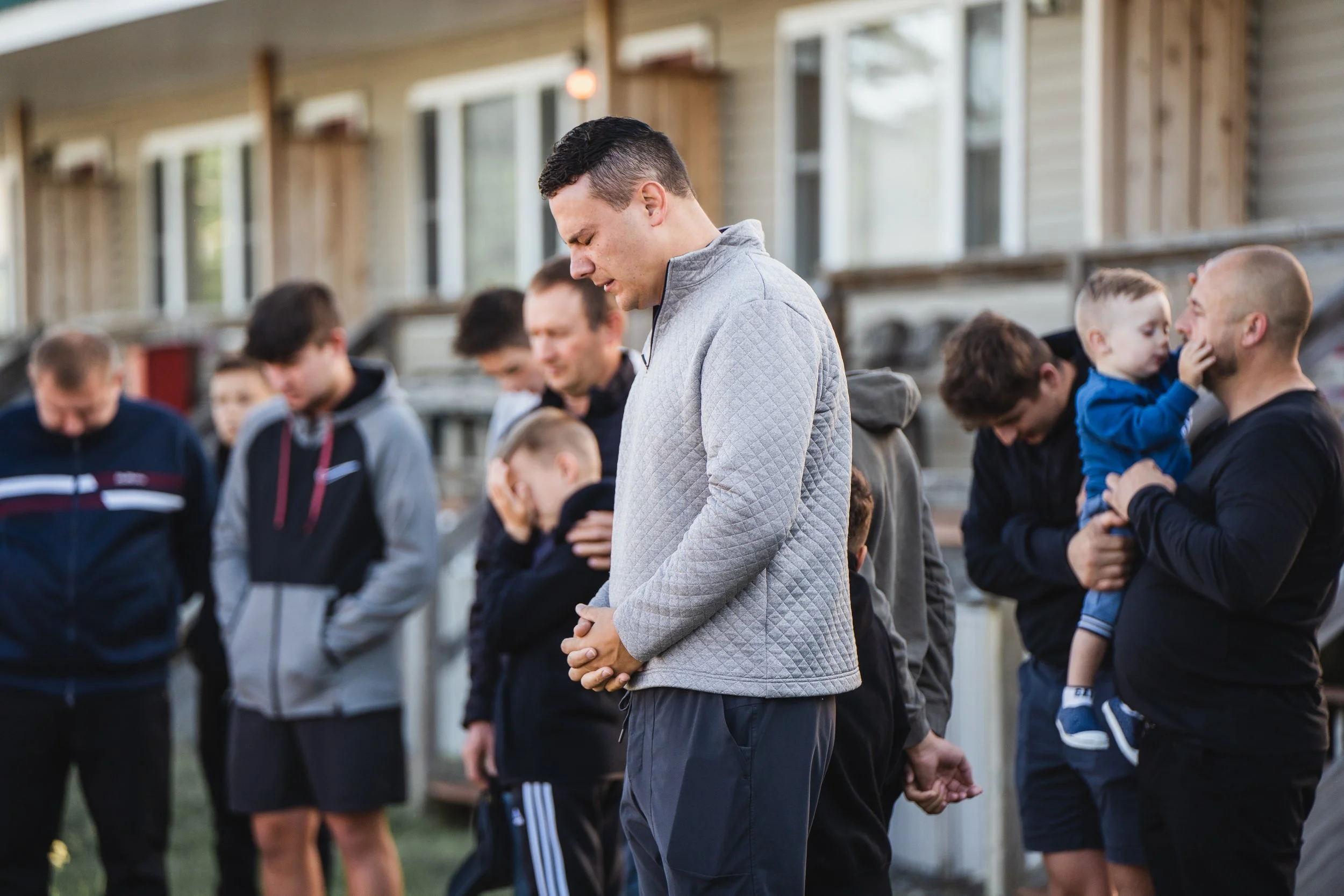 Men Praying at Men's Retreat at CAMP-of-the-WOODS
