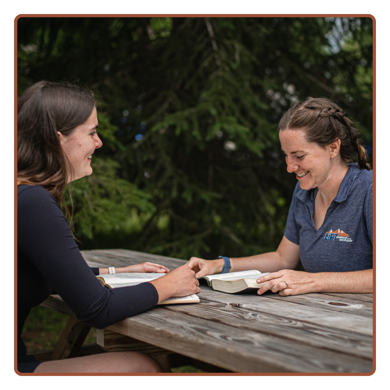 LIFT Staff mentoring and reading the Bible with student