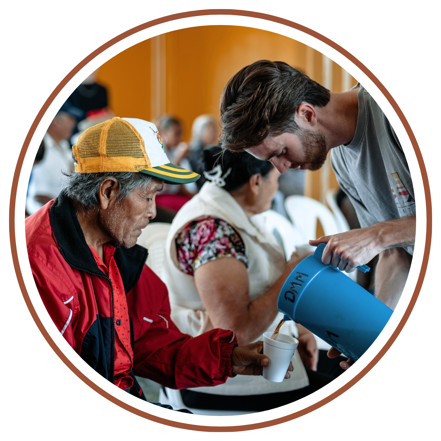 LIFT student serving a man water on a CAMP-of-the-WOODS mission trip