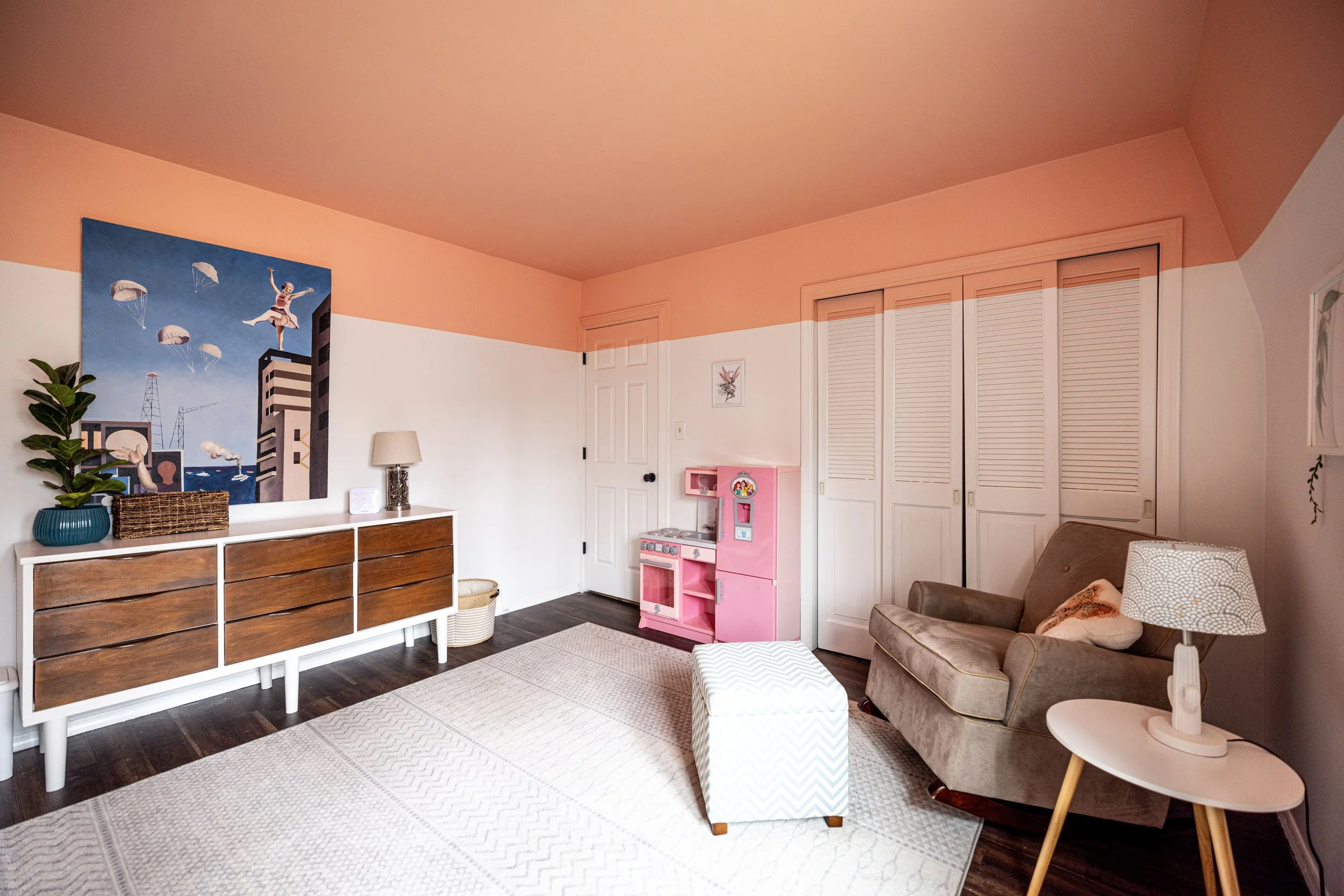 salmon color blocked bedroom with mid century dresser