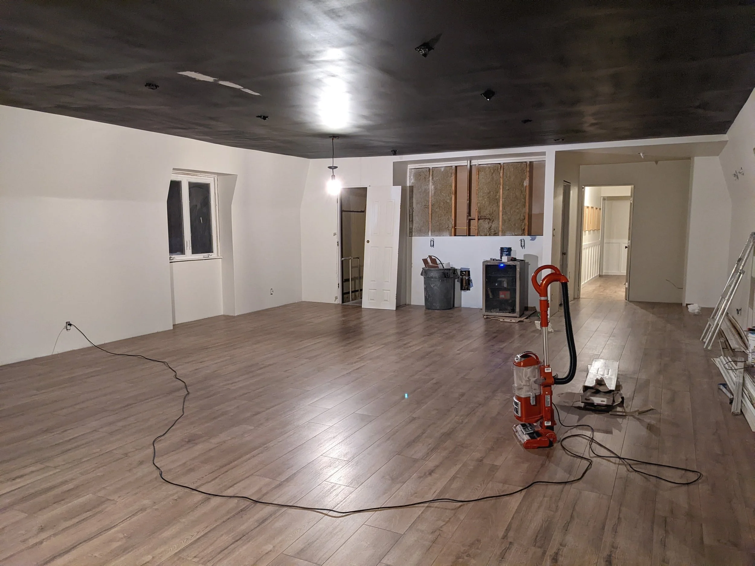 Empty rec room with black ceiling and white walls
