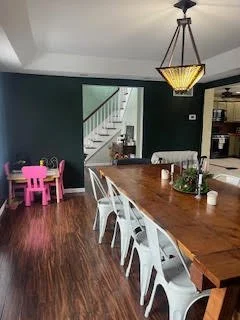 Dining room with green-toned walls before a full design makeover