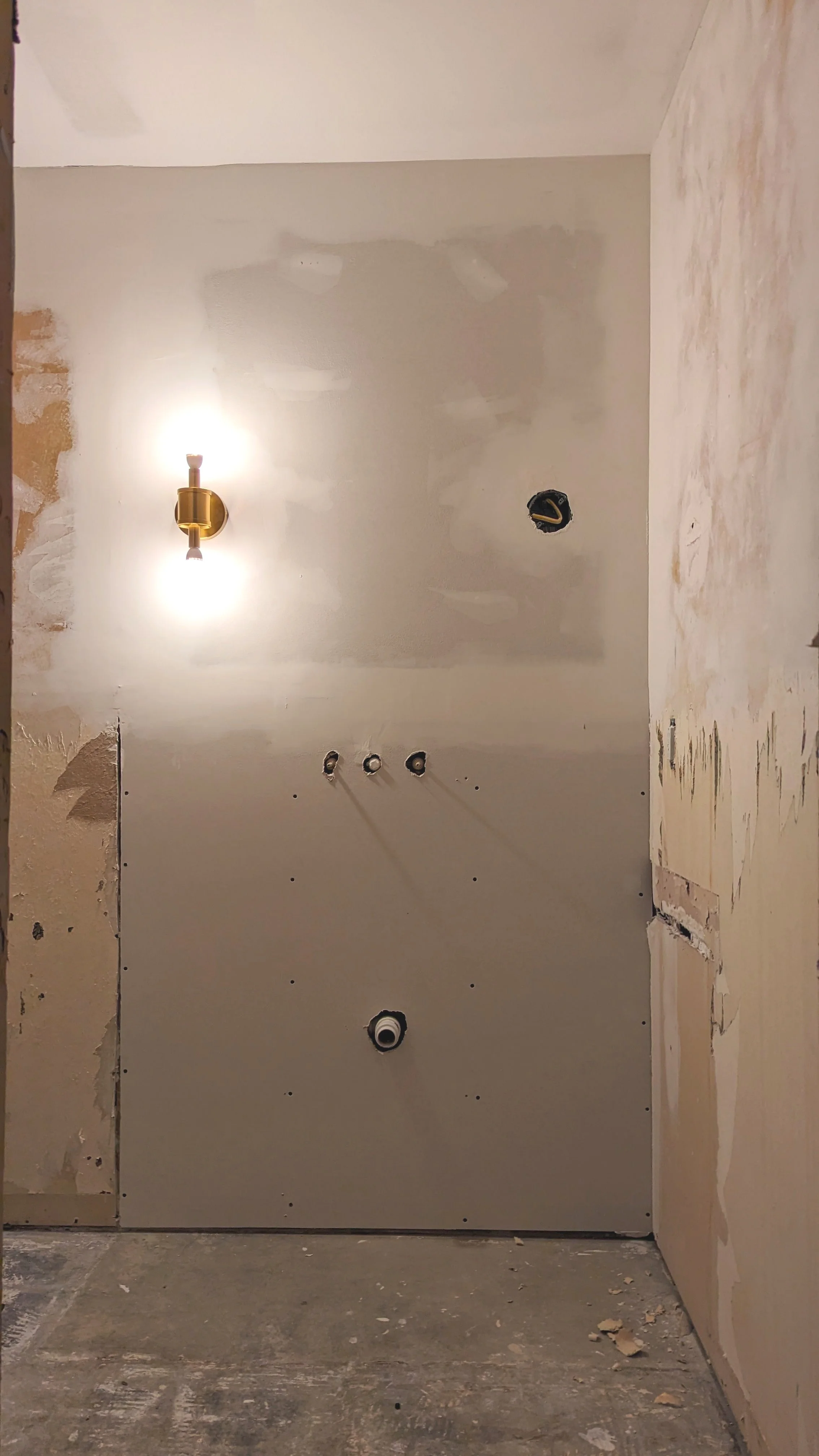 Freshly drywalled room with grass sconce
