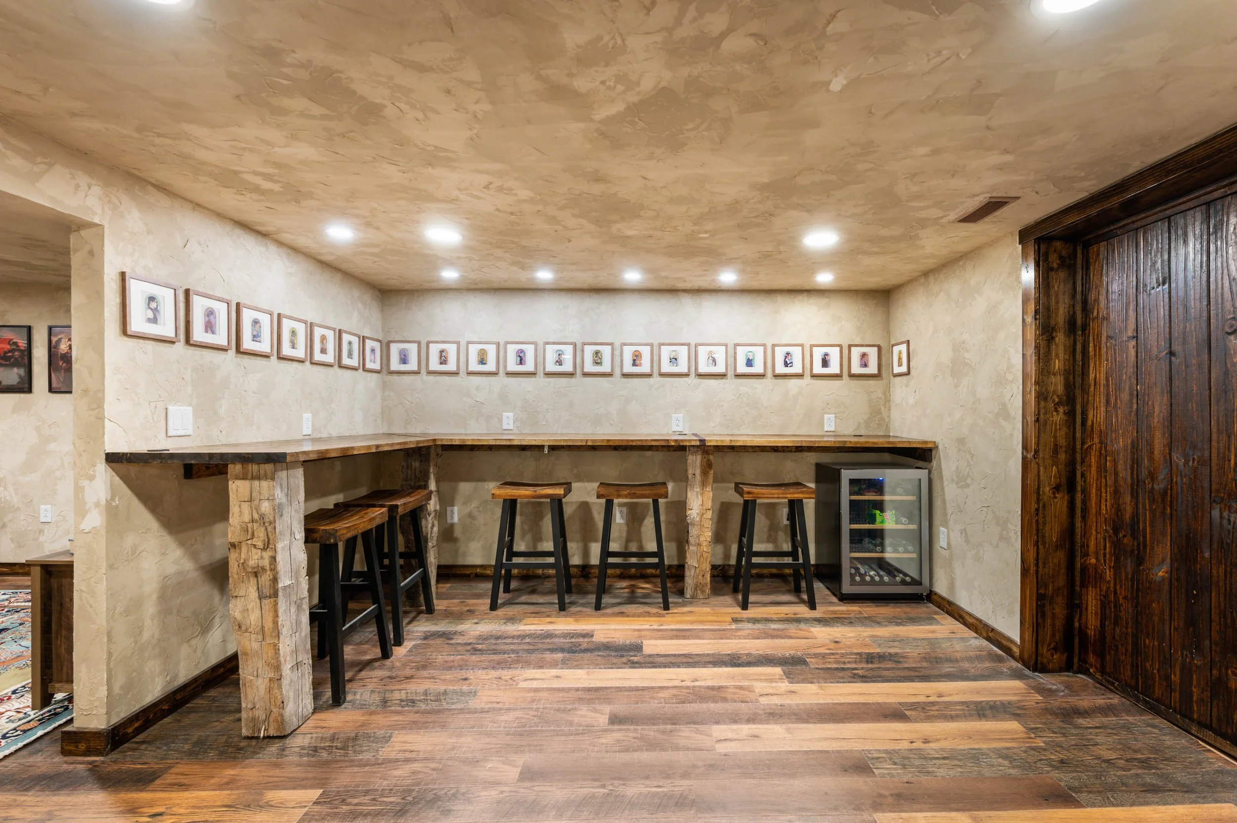 Craft room with bar stools and framed art gallery wall
