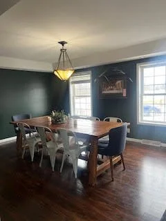 Dining room with green-toned walls before a full design makeover