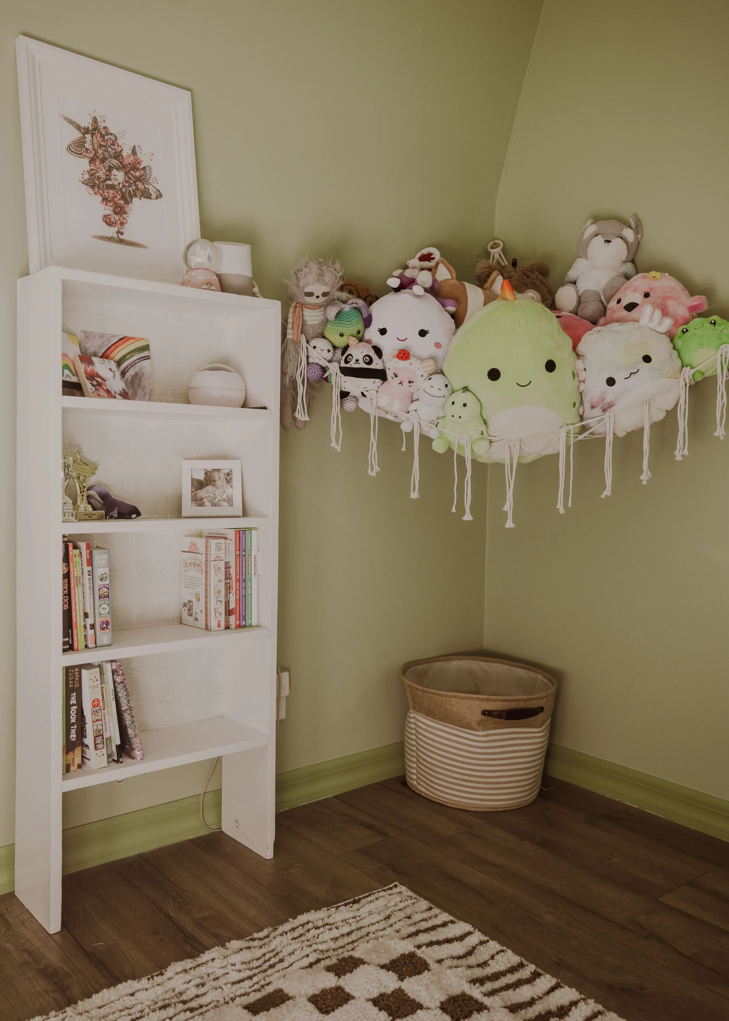 Stuffed animal hammock in corner of green tween bedroom