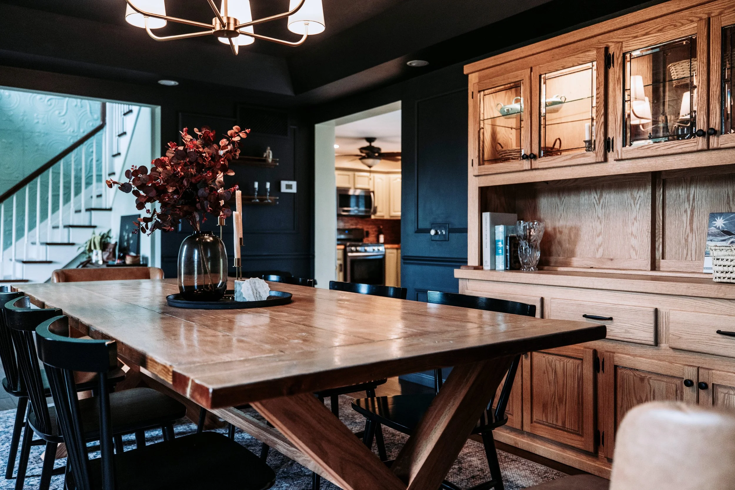 Styled wood hutch shelf in dark blue dining room