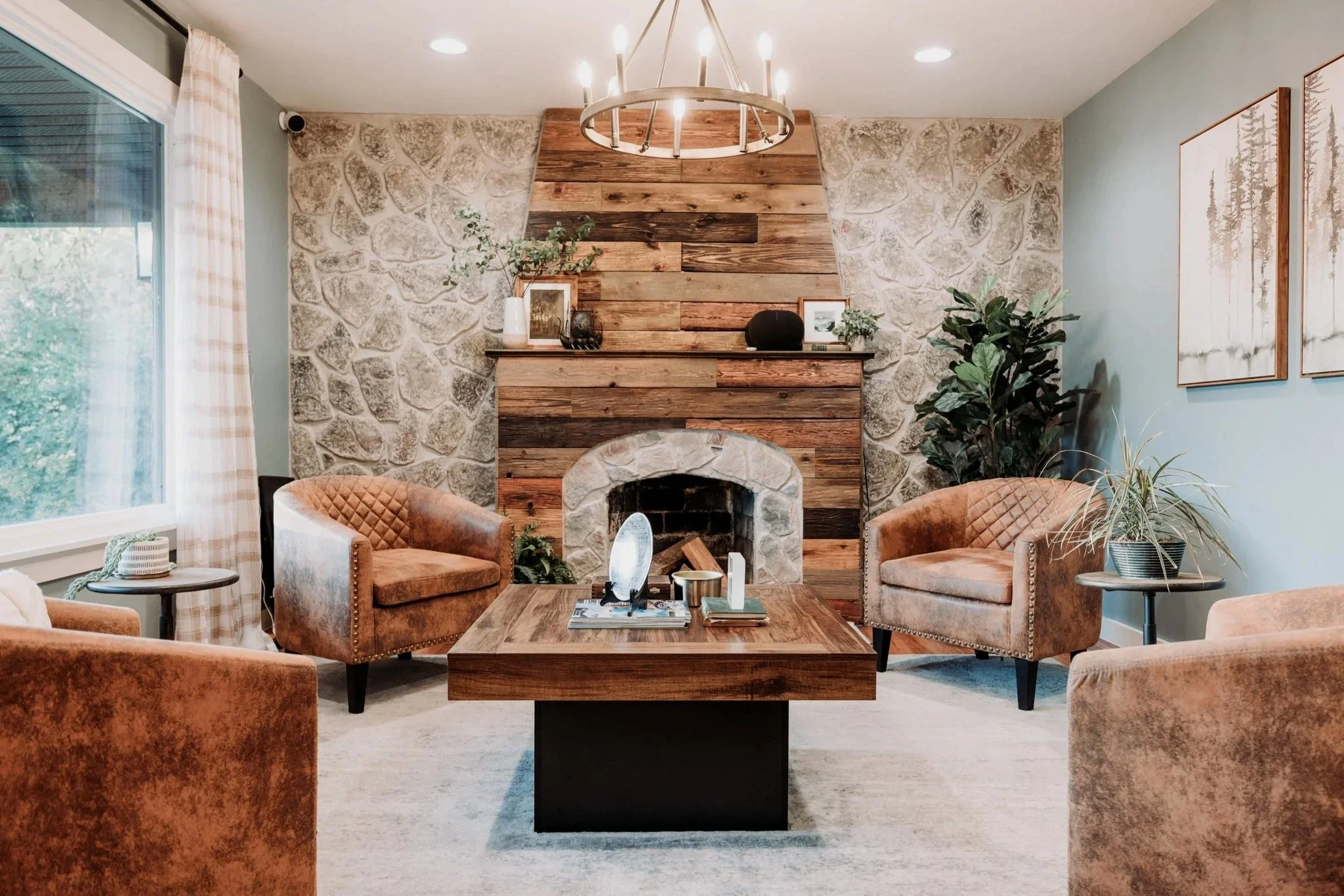 Wood-clad fireplace, stone, and chairs in lobby
