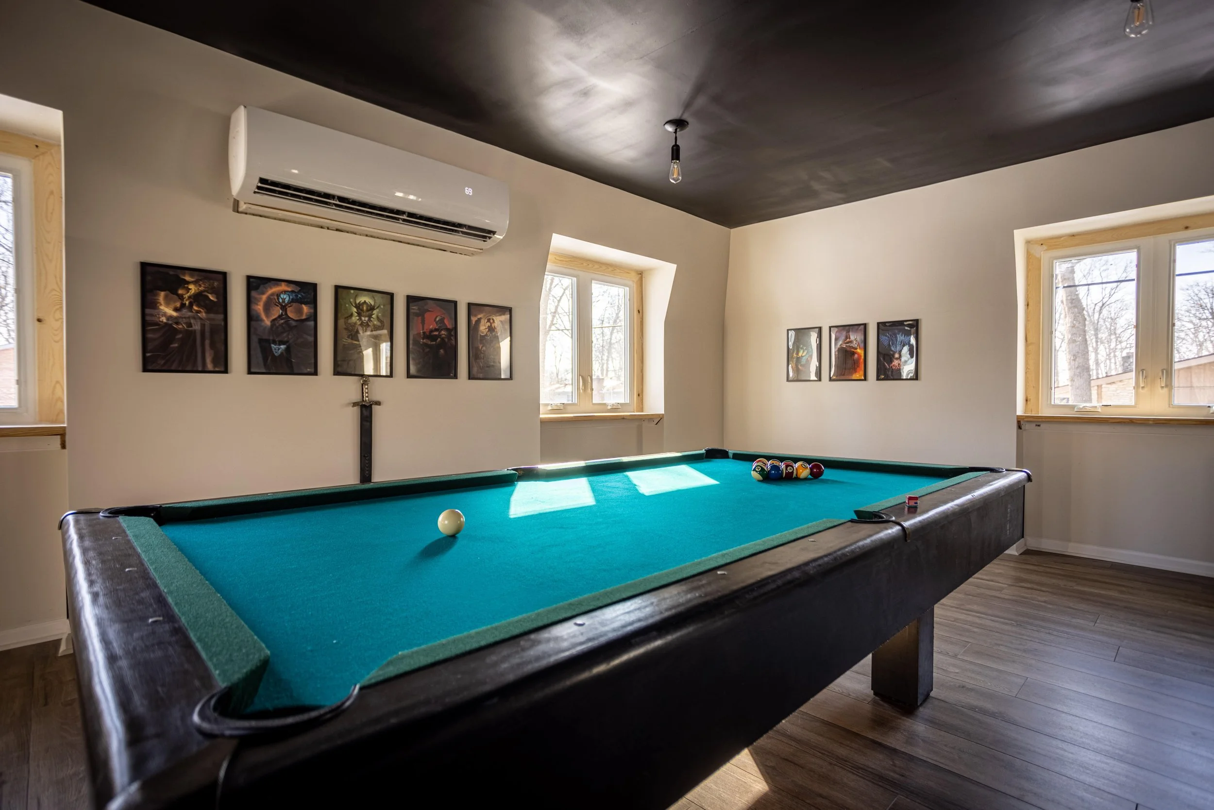 Pool table in rec room with black ceiling
