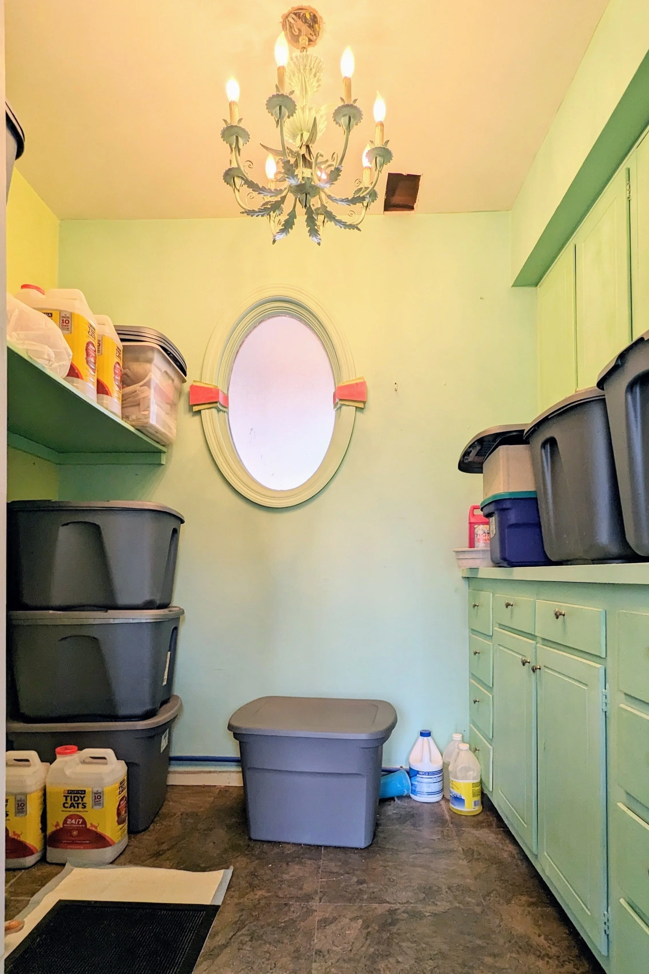 Storage room with grey totes and oval window