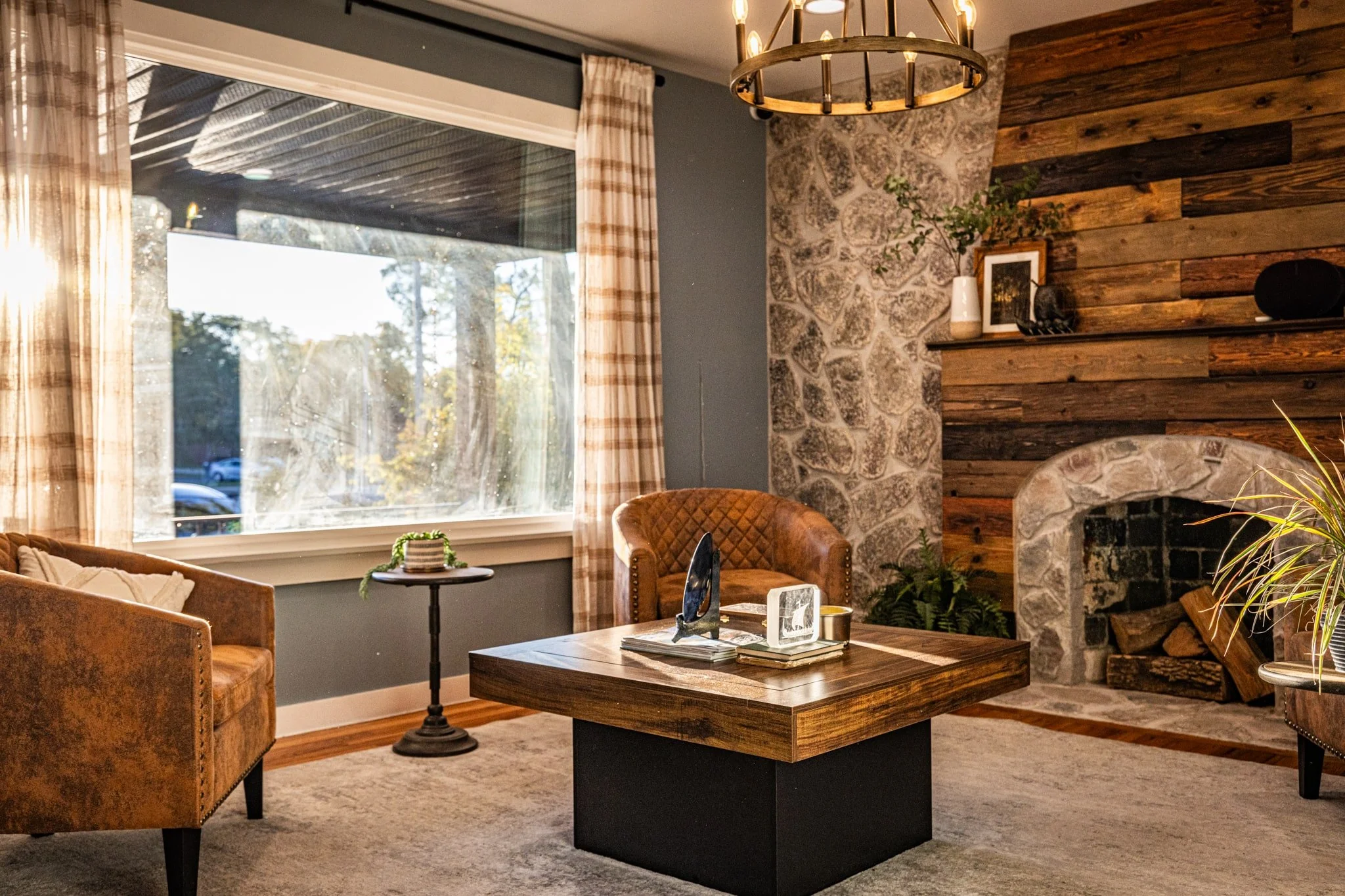 Warm rustic lobby with wood clad fireplace and stone walls