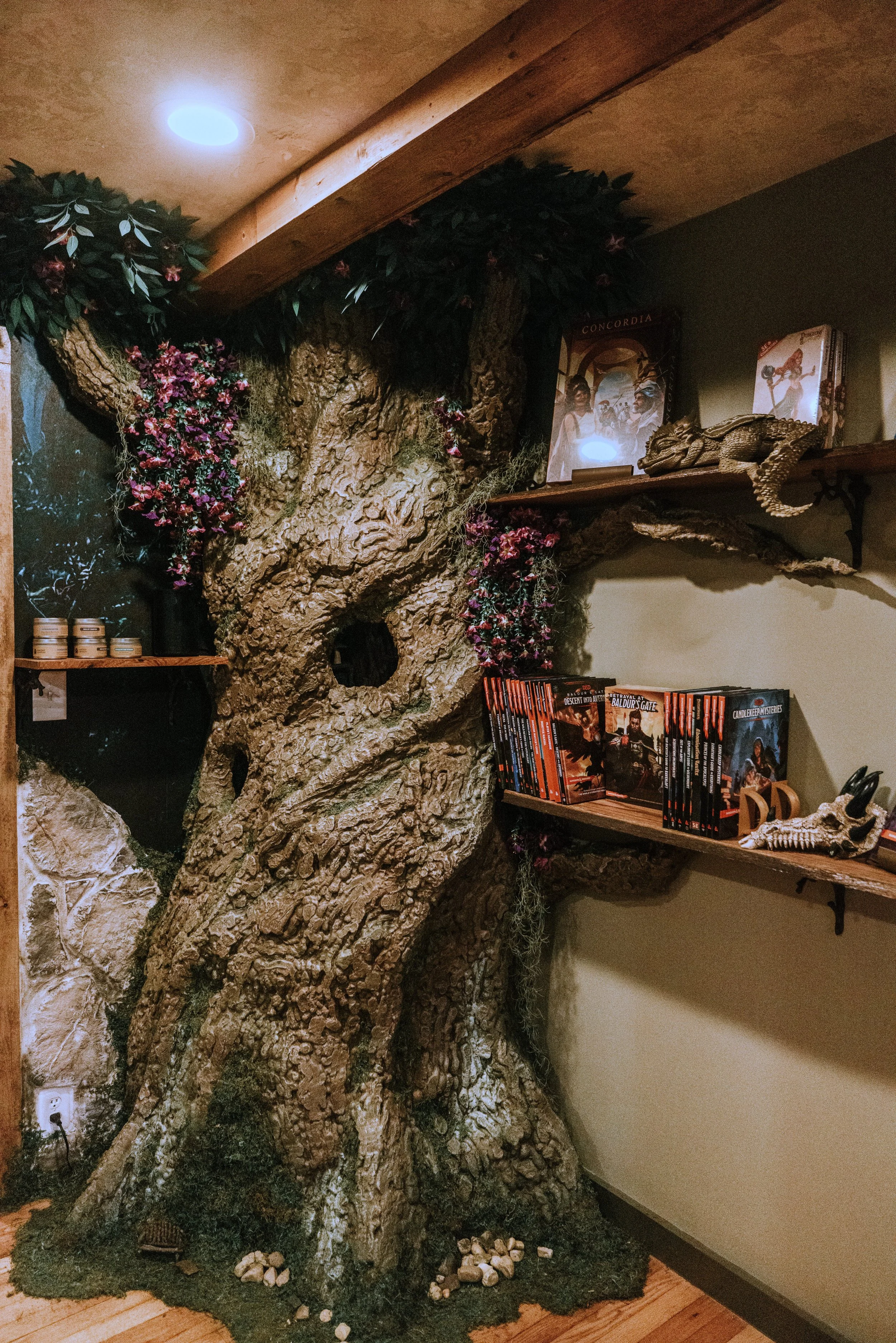 Hand-built 8-foot fantasy tree with moss, flowers, and live-edge display shelves