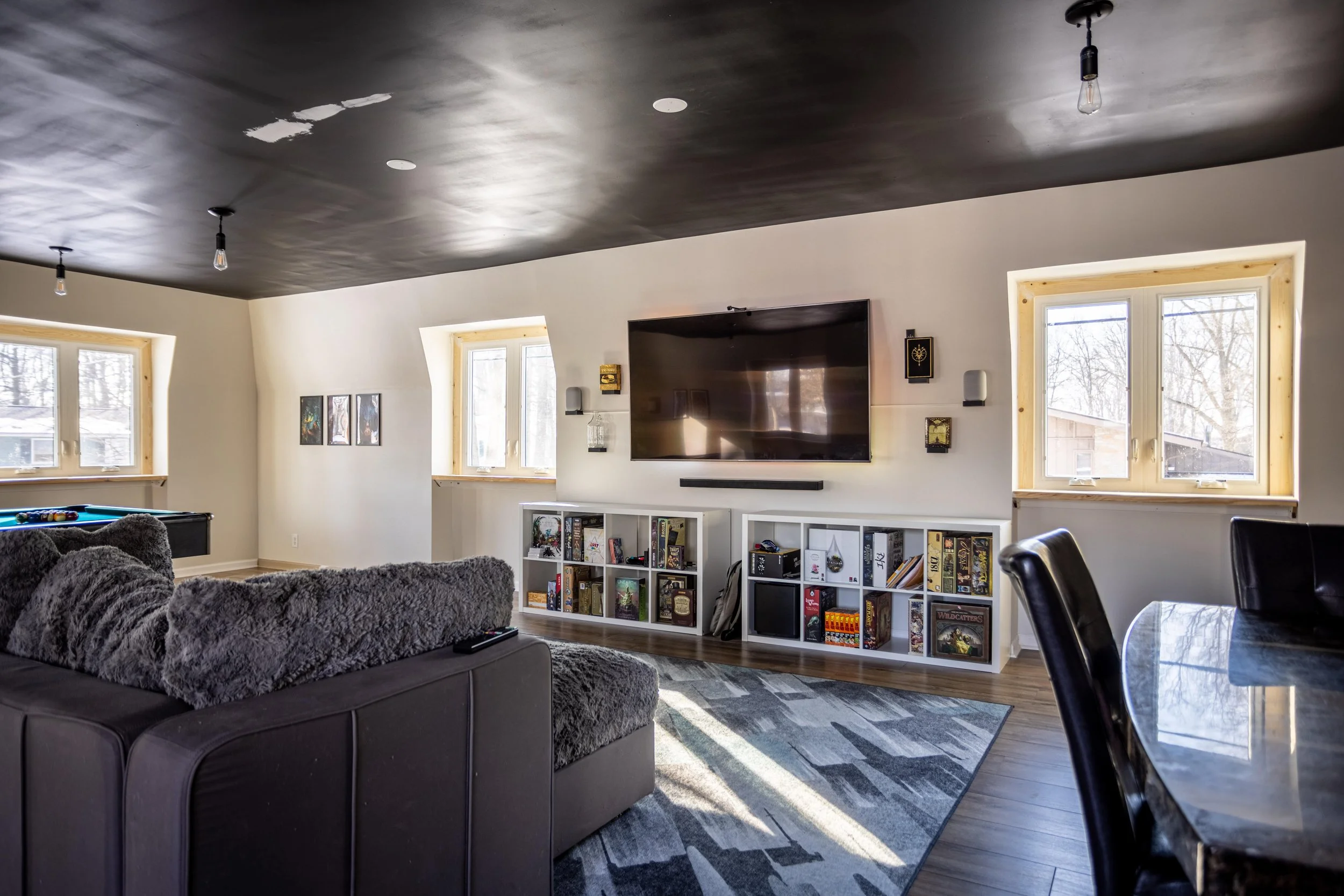 Bonus room with tv and bookshelves