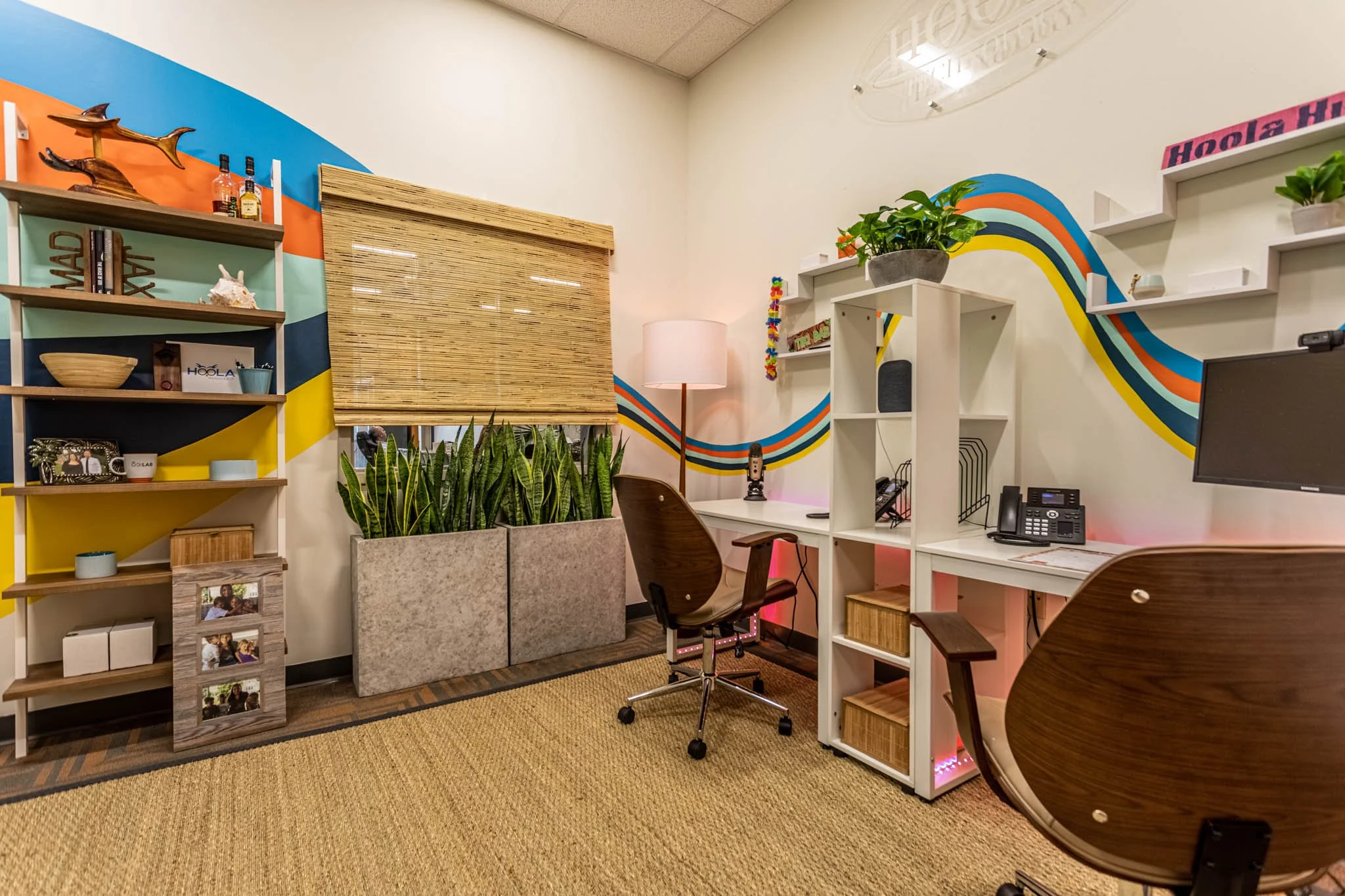 Office desk under hand-painted wave stripe mural