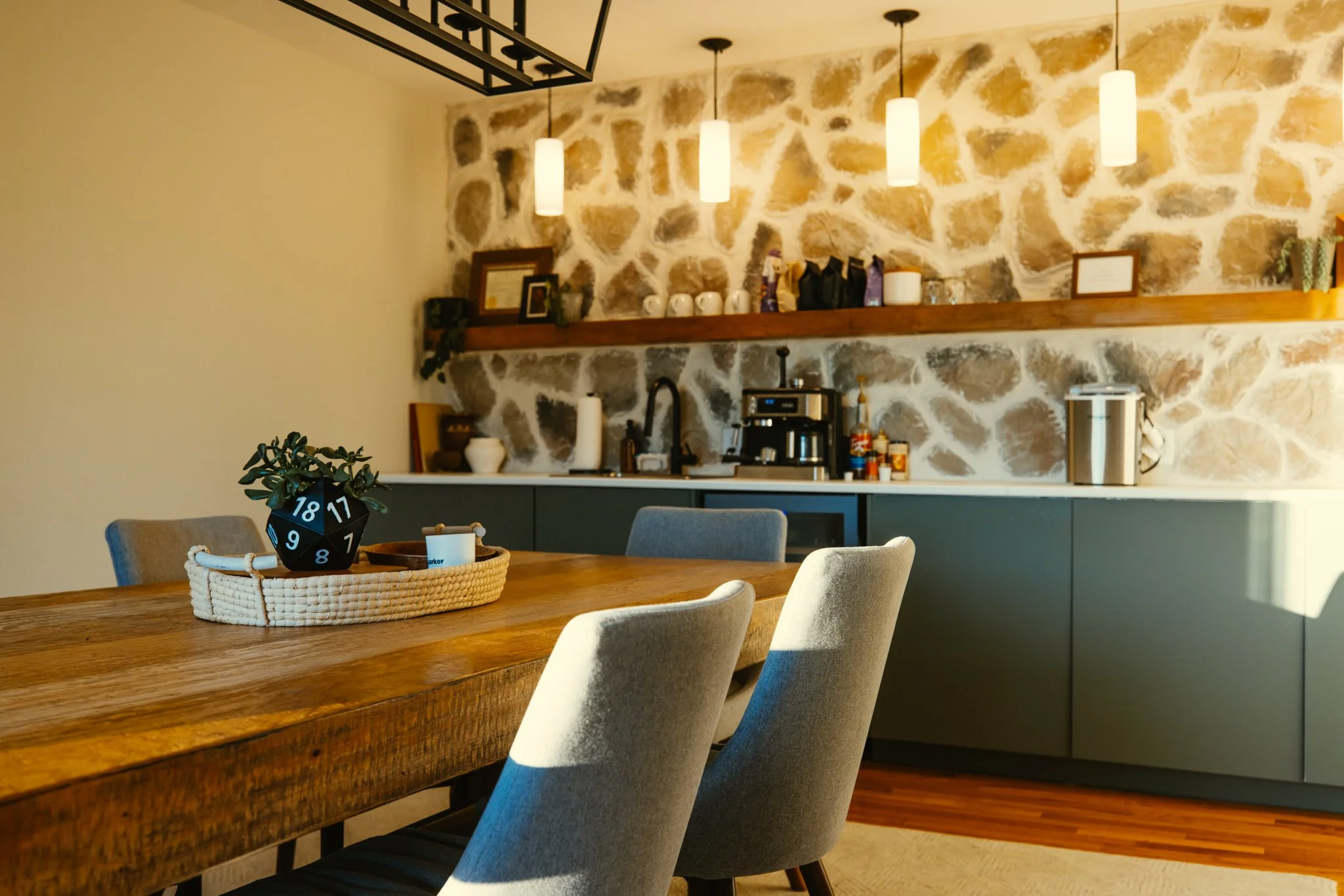 Conference room kitchenette with stone veneer wall and pendant lights