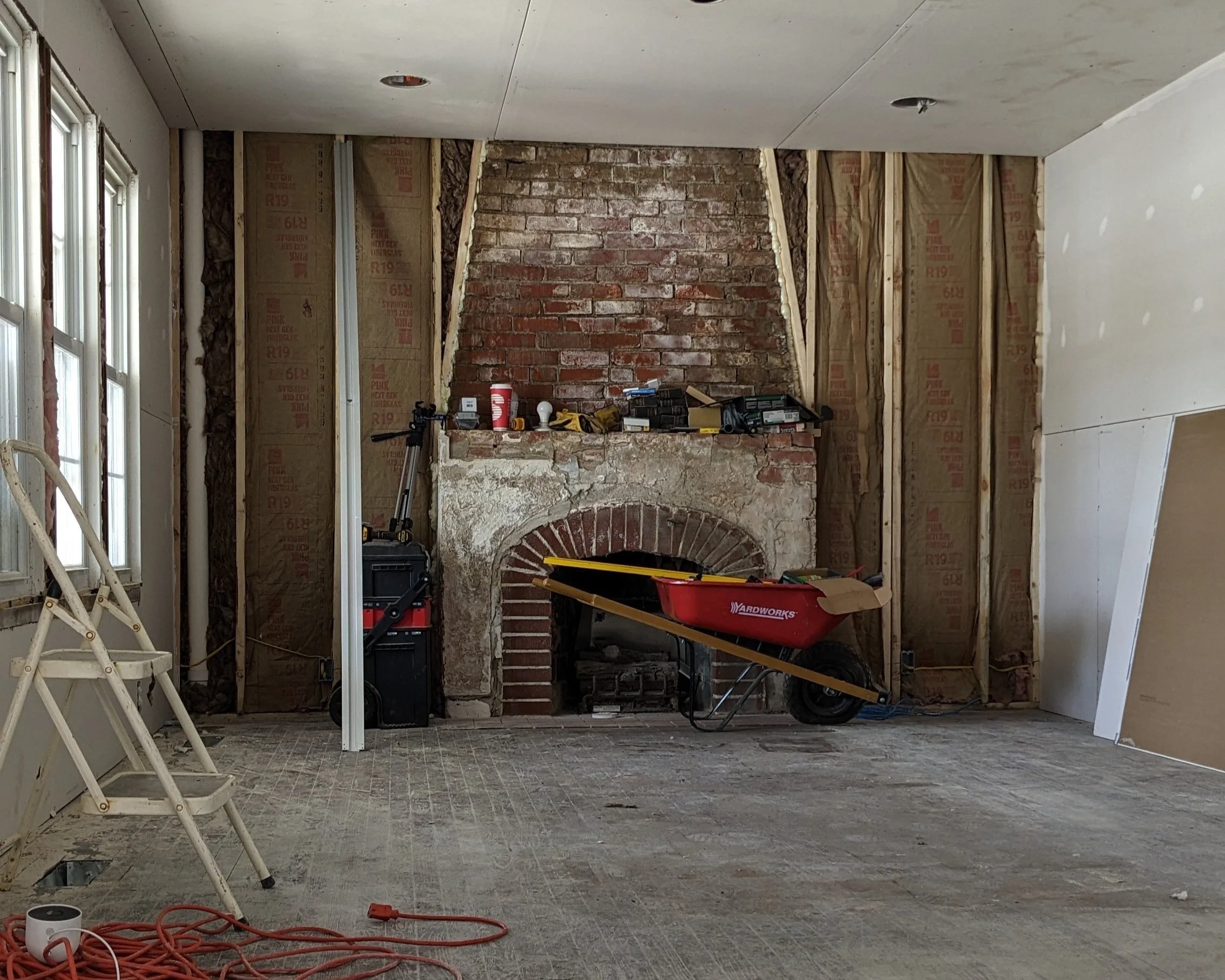 Room during construction with fireplace