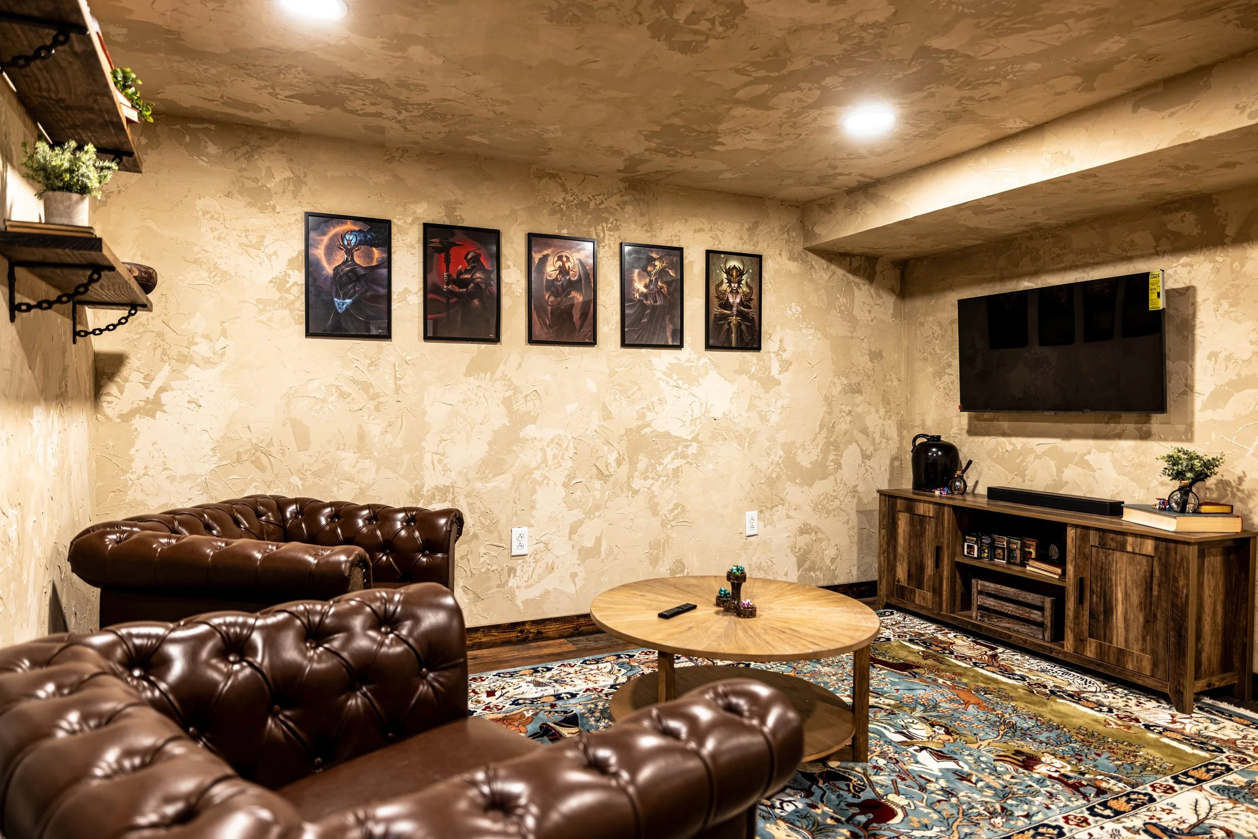 Leather lounge chairs and wood media console in gaming venue