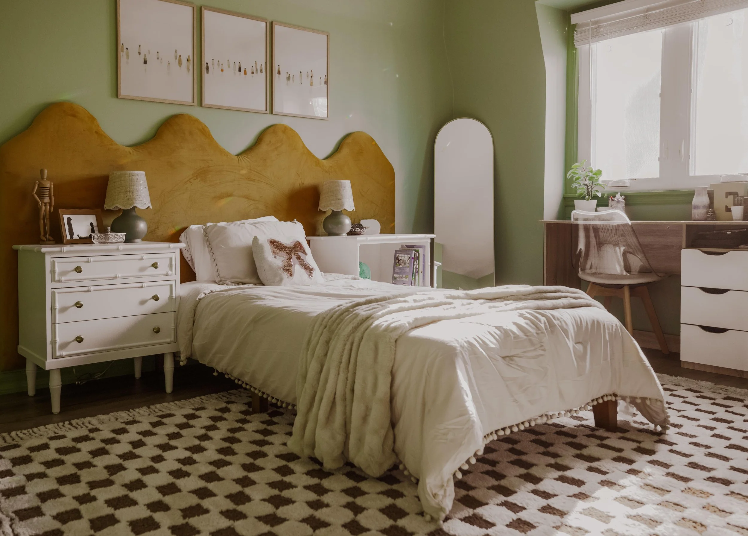 Tween bedroom with green walls, mustard headboard, and checkered rug