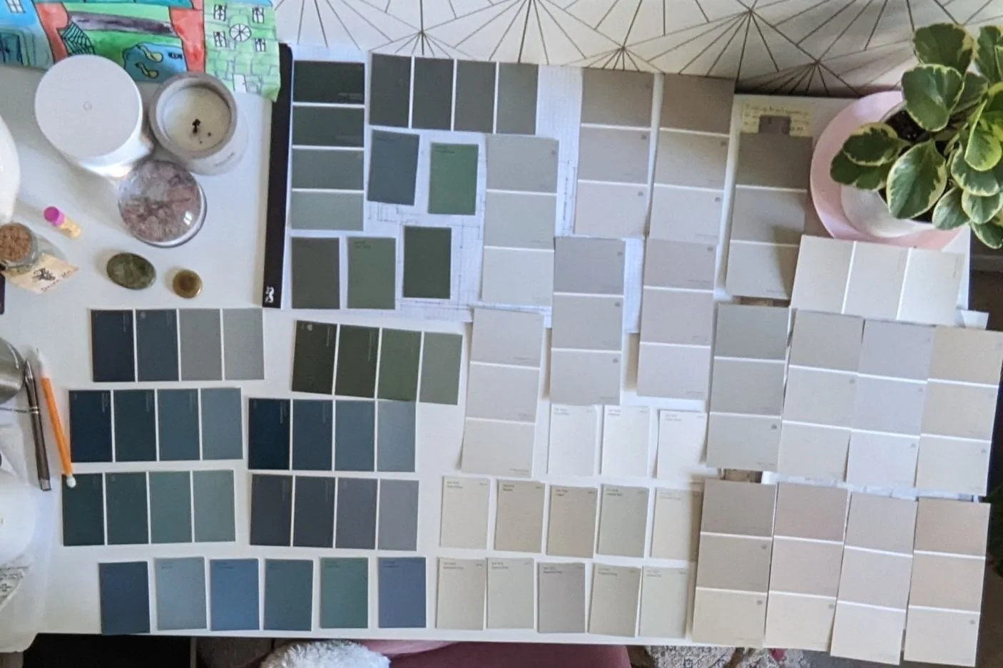 Blue, green, and taupe paint chips on desk