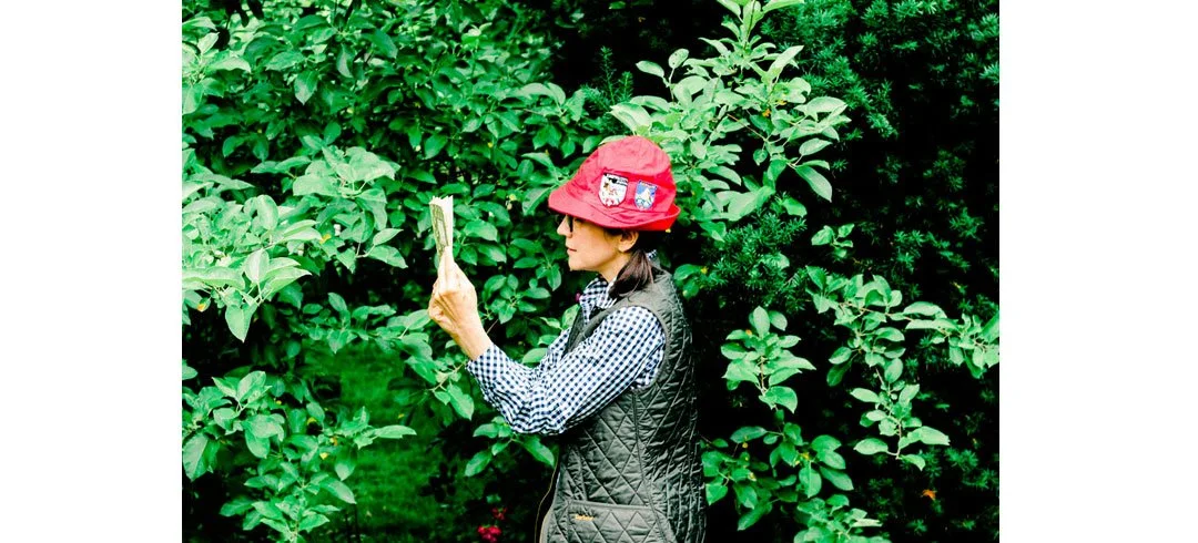 Nancy Nikko in red alpine hat, reading
