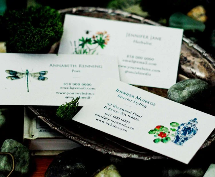 Collection of business cards by Florian Gray on silver tray.