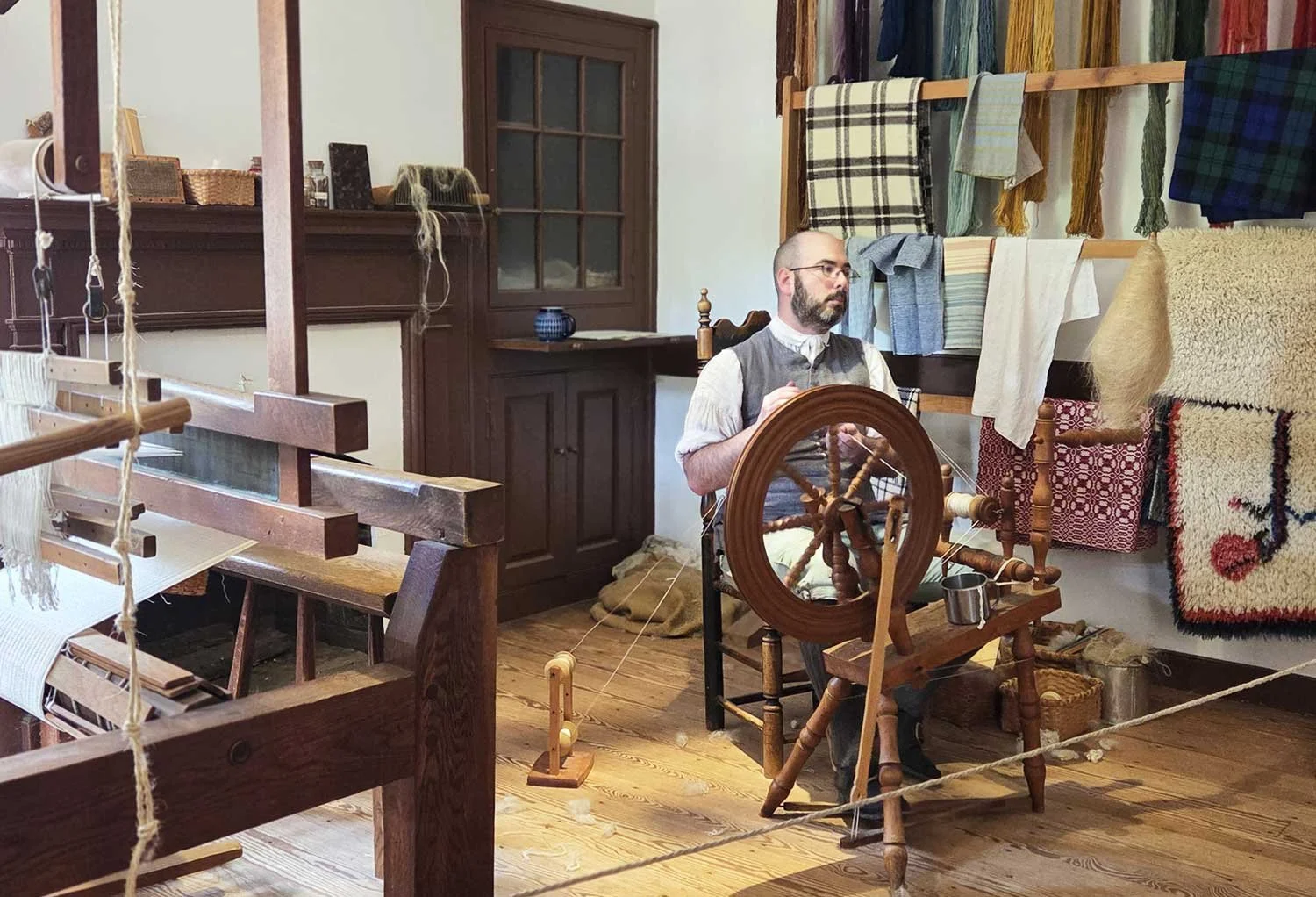 Reenactor with spinning wheel.