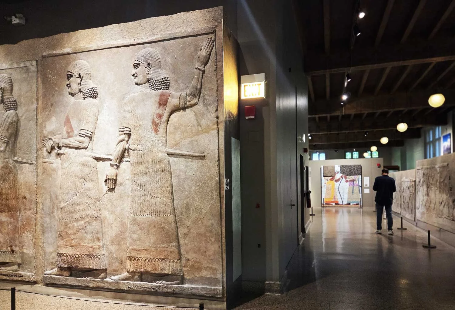 Assyrian courtiers in stone relief.