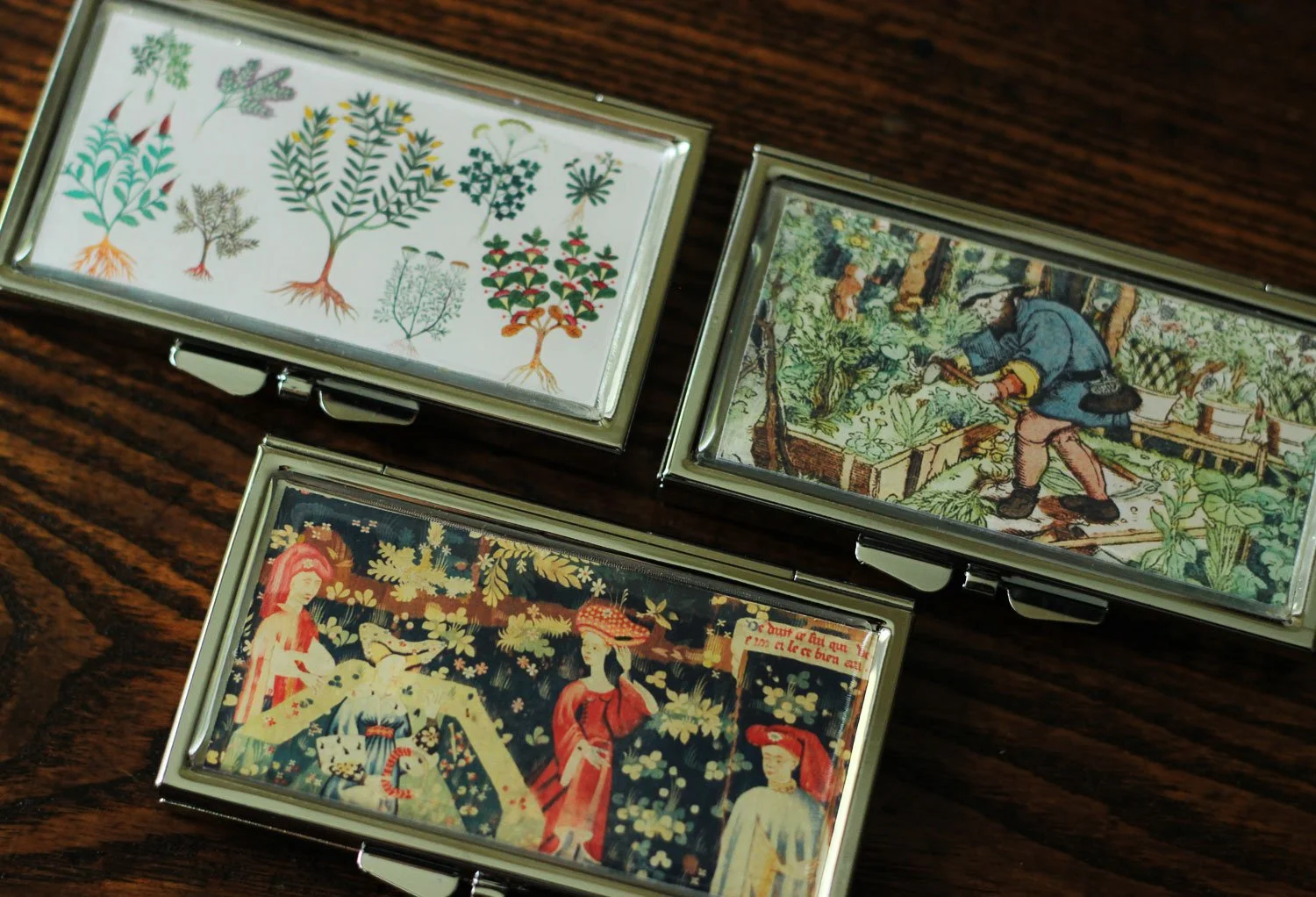 Metal pillboxes with medieval designs.